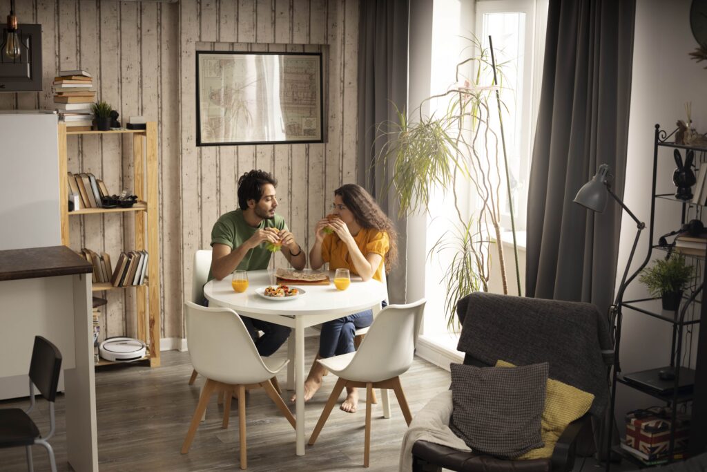 couple-enjoying-lunch-with-sandwiches-home