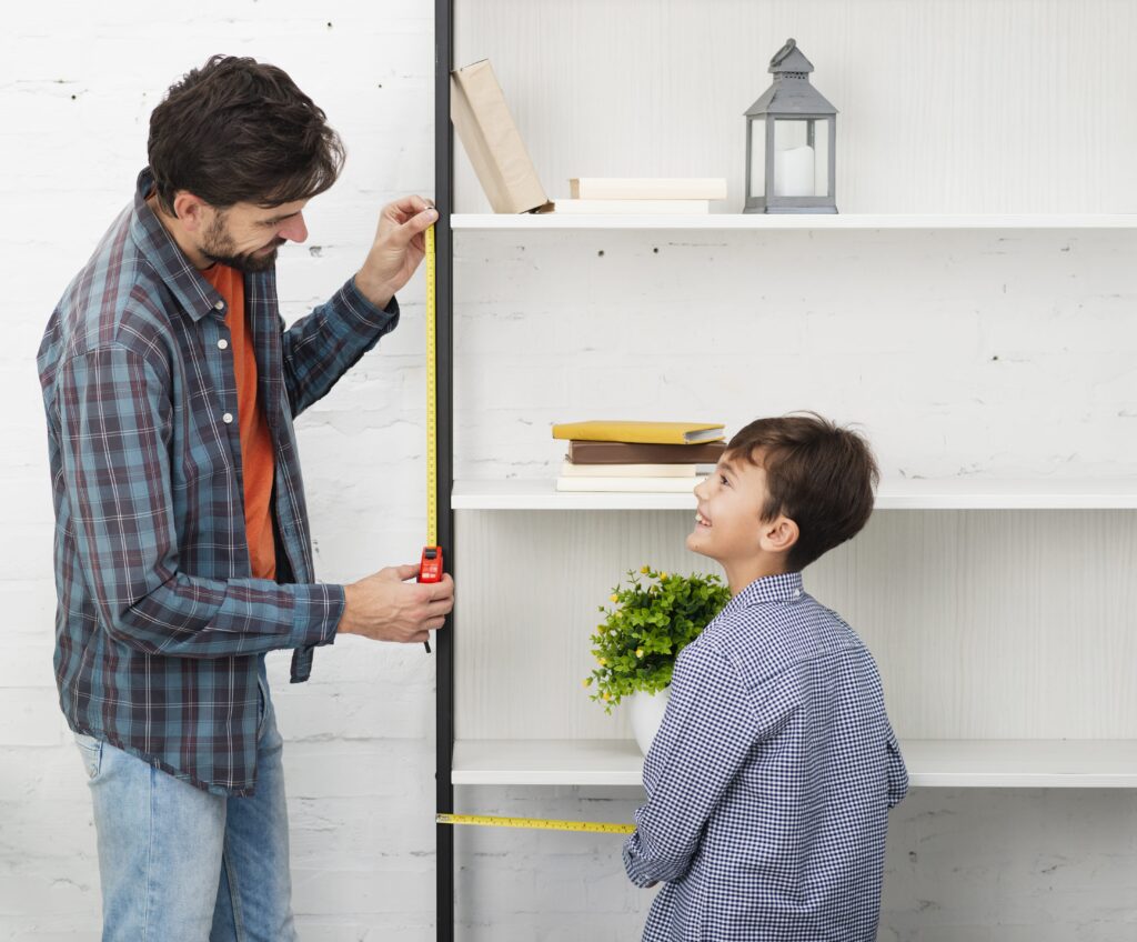 father-son-measuring-shelf